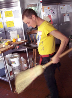 A Coop member cleaning their houses kitchen.